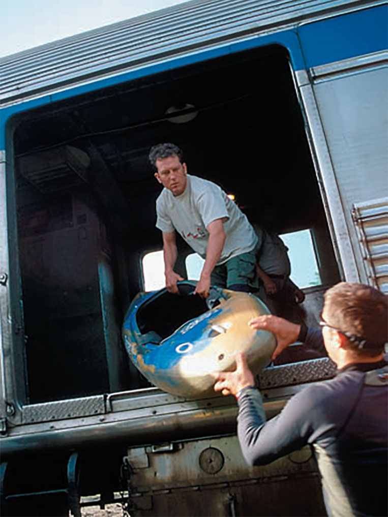 two men load a whitewater kayak onto a train in Northern Ontario