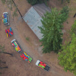 Wave Theory: Is The Classic Kayaker Greeting Making A Comeback? overhead photo of a pair of vans hauling many many river kayaks