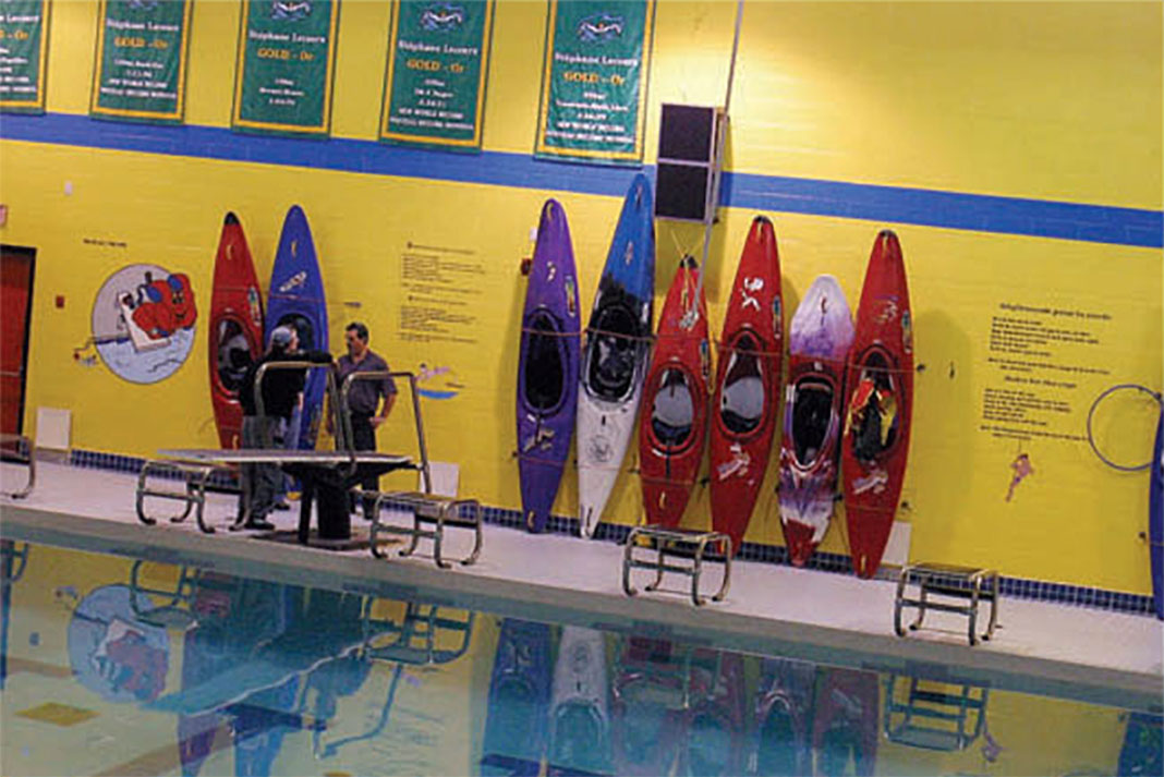 Kayaks lined up in the Hearst pool ready for lessons