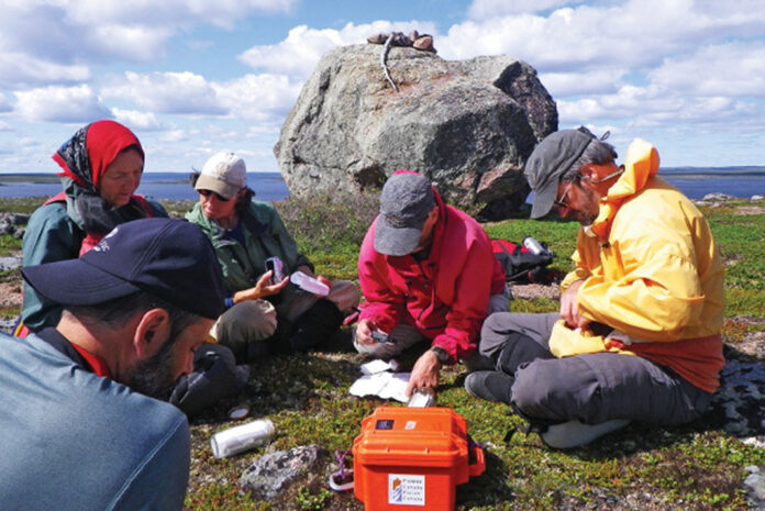 people review the notes left in a bottle by generations of wilderness canoeists