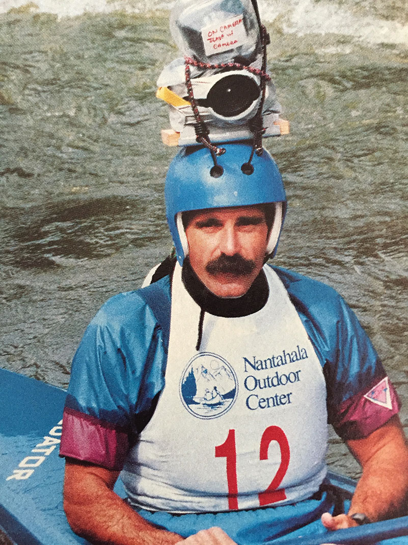 paddler from the 1980s poses with DIY camera tied to the top of his whitewater helmet