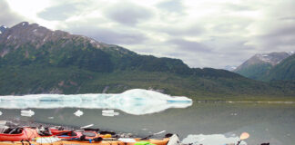 a group of beached sea kayaks on an Alaskan paddling expedition