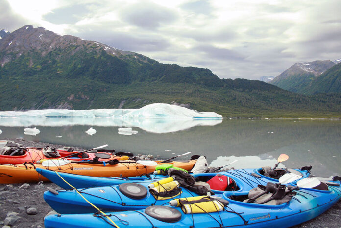 a group of beached sea kayaks on an Alaskan paddling expedition