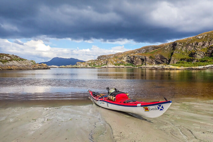 a sea kayak sits on the Scottish coast during an expedition