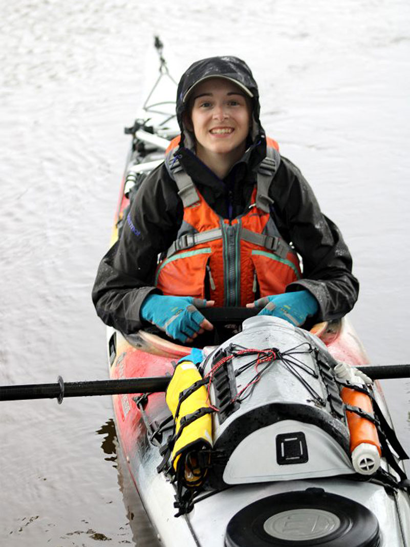 Mason Eklund poses in her sea kayak during the expedition