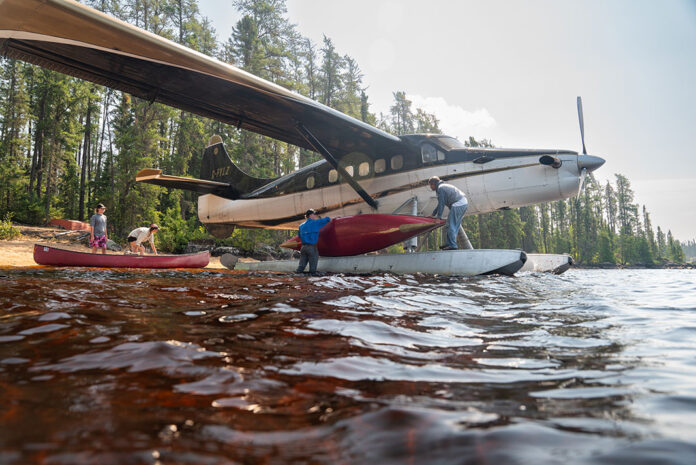 People load canoes onto a float plane used by Wabakimi Outfitters