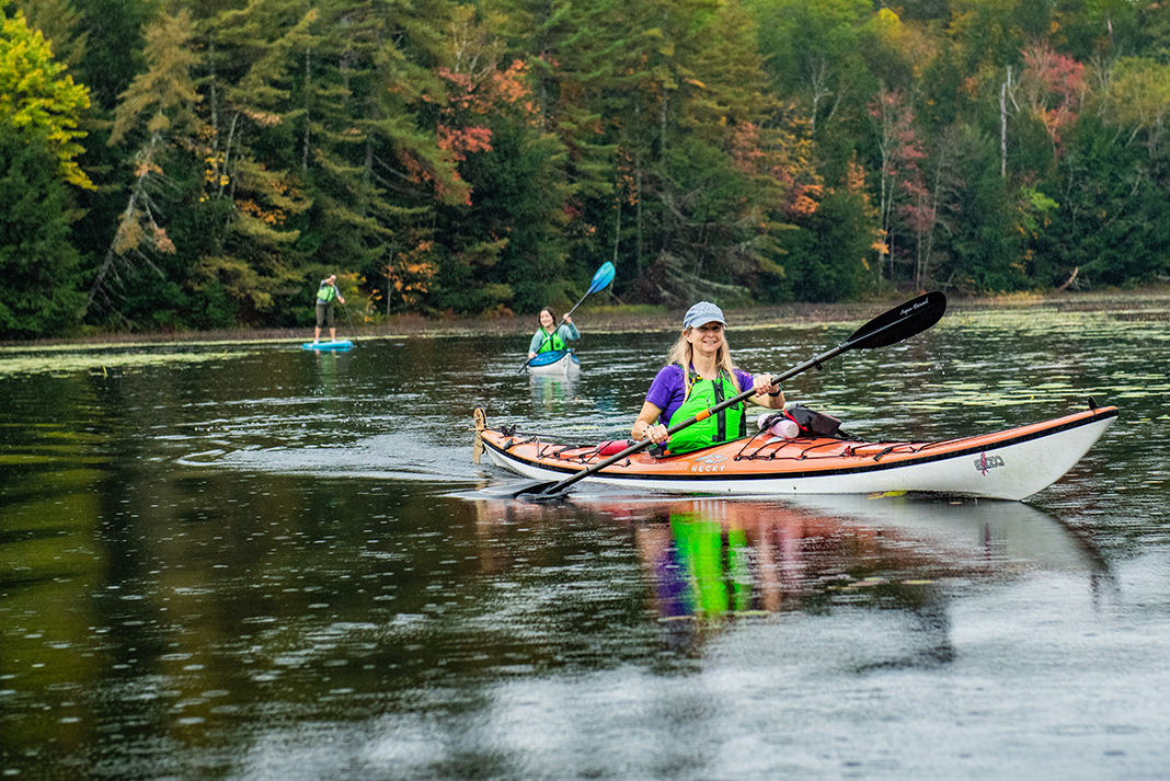women paddling kayaks