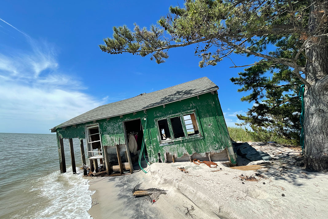 a waterside building collapses into Chesapeake Bay in signs of shoreline erosion