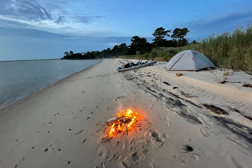 a beach campsite with campfire during John Hostalka's Chesapeake Bay tour
