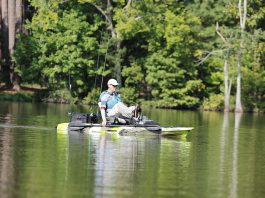 man sits and pedals the Feelfree Lure 11.5 V2 with Overdrive fishing kayak