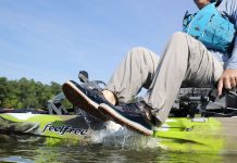 kayak angler lifts his fishing shoes out of water while sitting on the kayak