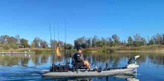 man fishes from a kayak with a trolling motor installed