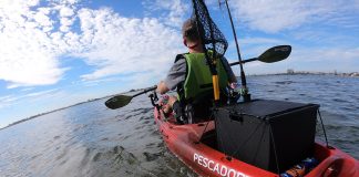 man paddles a Perception Pescador 10 fishing kayak