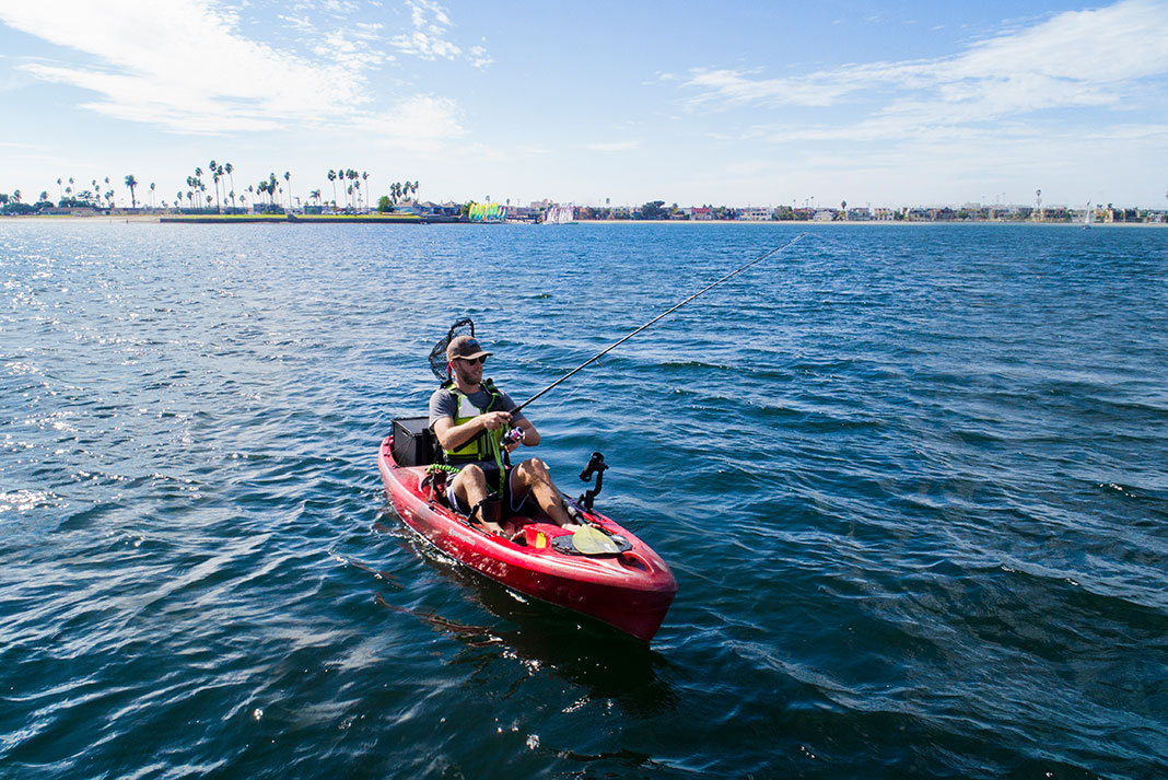 man fishes from the Pescador 10 fishing kayak