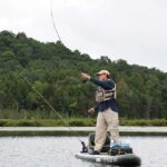 Oseetah Lake Is Upstate New York’s Hidden Jewel kayak angler stands and casts at Lake Oseetah in New York's Adirondack Mountains