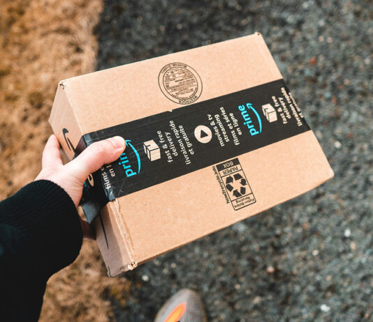 person holding an Amazon Prime delivery