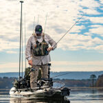 8 Of The Best-Kept Secret Bass Fishing Spots In Alabama Chad Hoover stands on his kayak and grabs hold of a fishing rod on a lake in Alabama