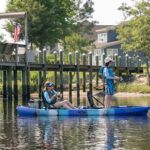 Best Tandem Fishing Kayaks For 2026 two women fish and paddle the Brooklyn Kayak Company TK122 tandem fishing kayak