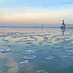 icy water on Lake Michigan in front of a lighthouse, where you can catch coho salmon