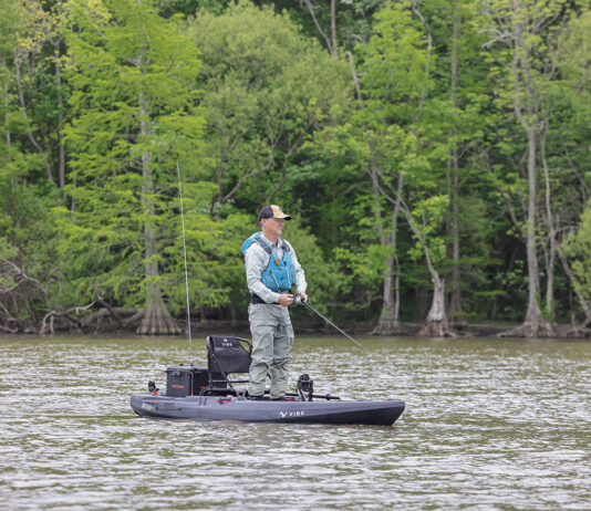 man stands and fishes from the Vibe Makana 100 pedal kayak