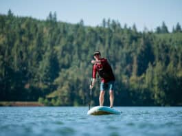 Niphean inflatable paddleboard being used on lake.