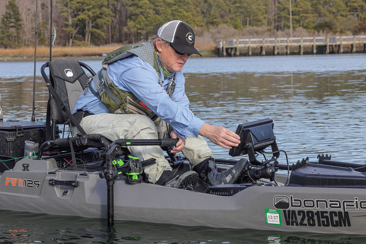 Ric Burnley adjusts the single display on his fishing kayak electronics system