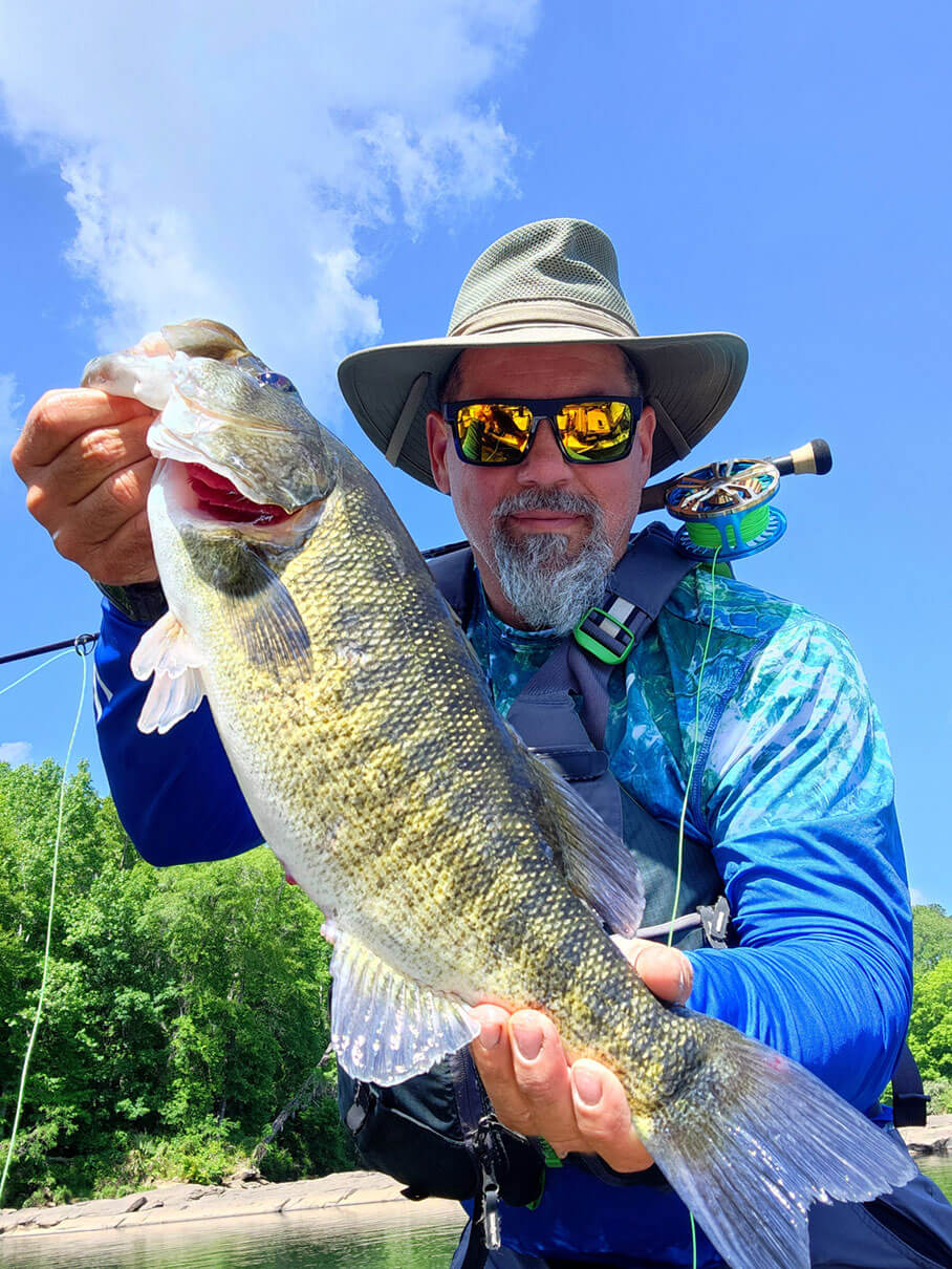 kayak angler chris funk displays a shoal bass he caught to the camera