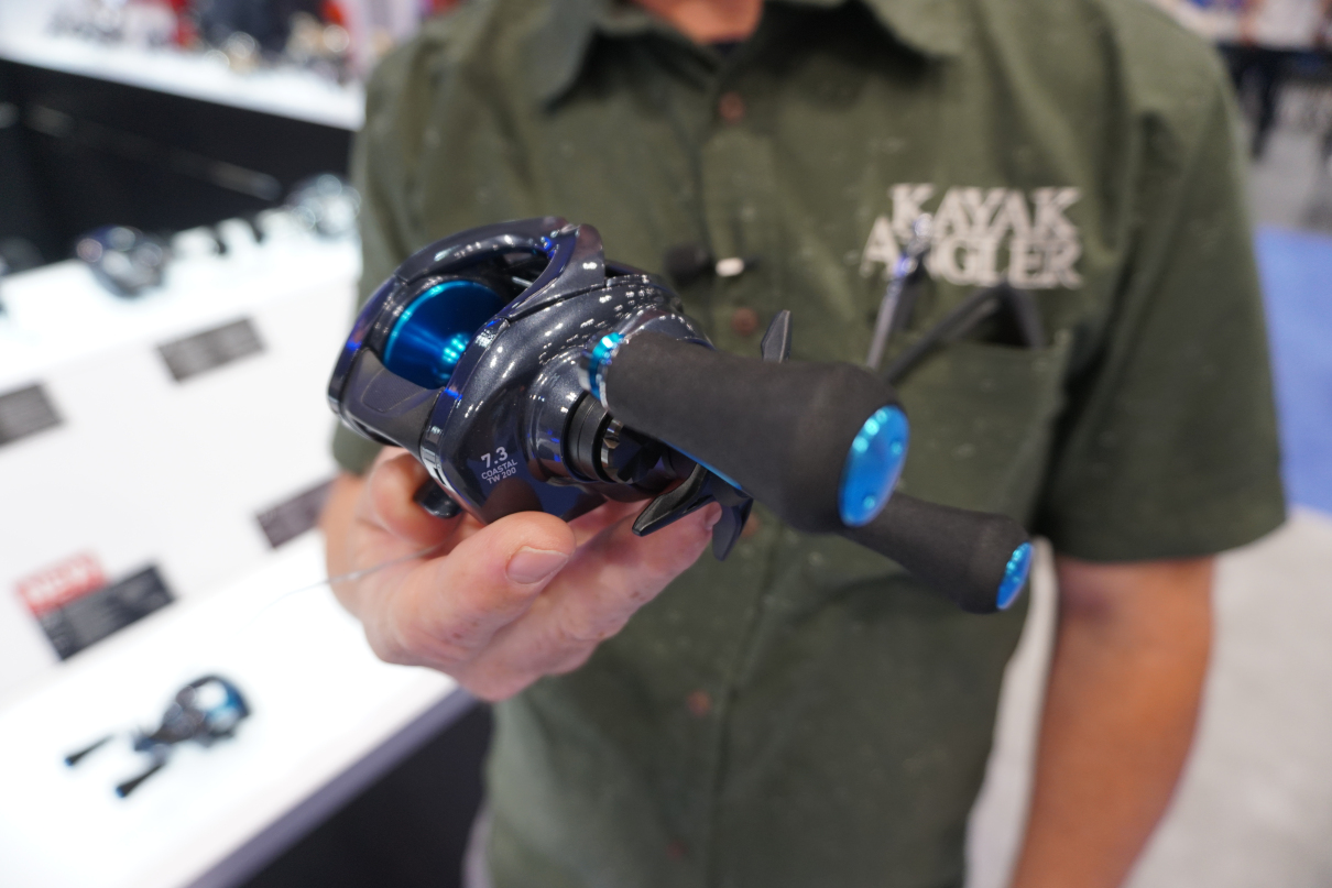 Kayak Angler editor Rick Burnley holds the new Daiwa Coastal TW 200 reel at ICAST 2025