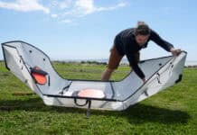 Man folding a portable kayak into shape.