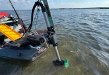 Newport Vessels trolling motor attached to kayak on water.