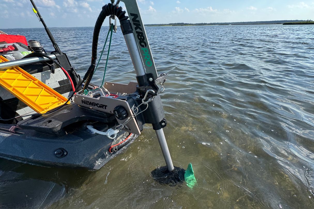 Newport Vessels trolling motor attached to kayak on water.