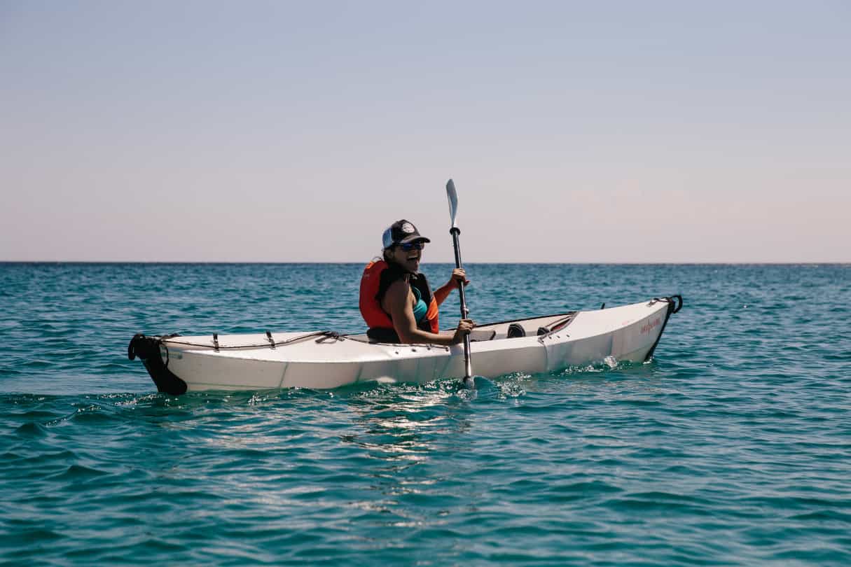 The Oru Inlet origami-inspired folding kayak being paddled out on open water.