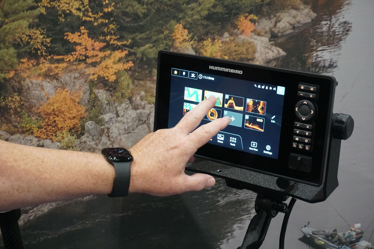 a person uses the touch screen on a Humminbird fish finder