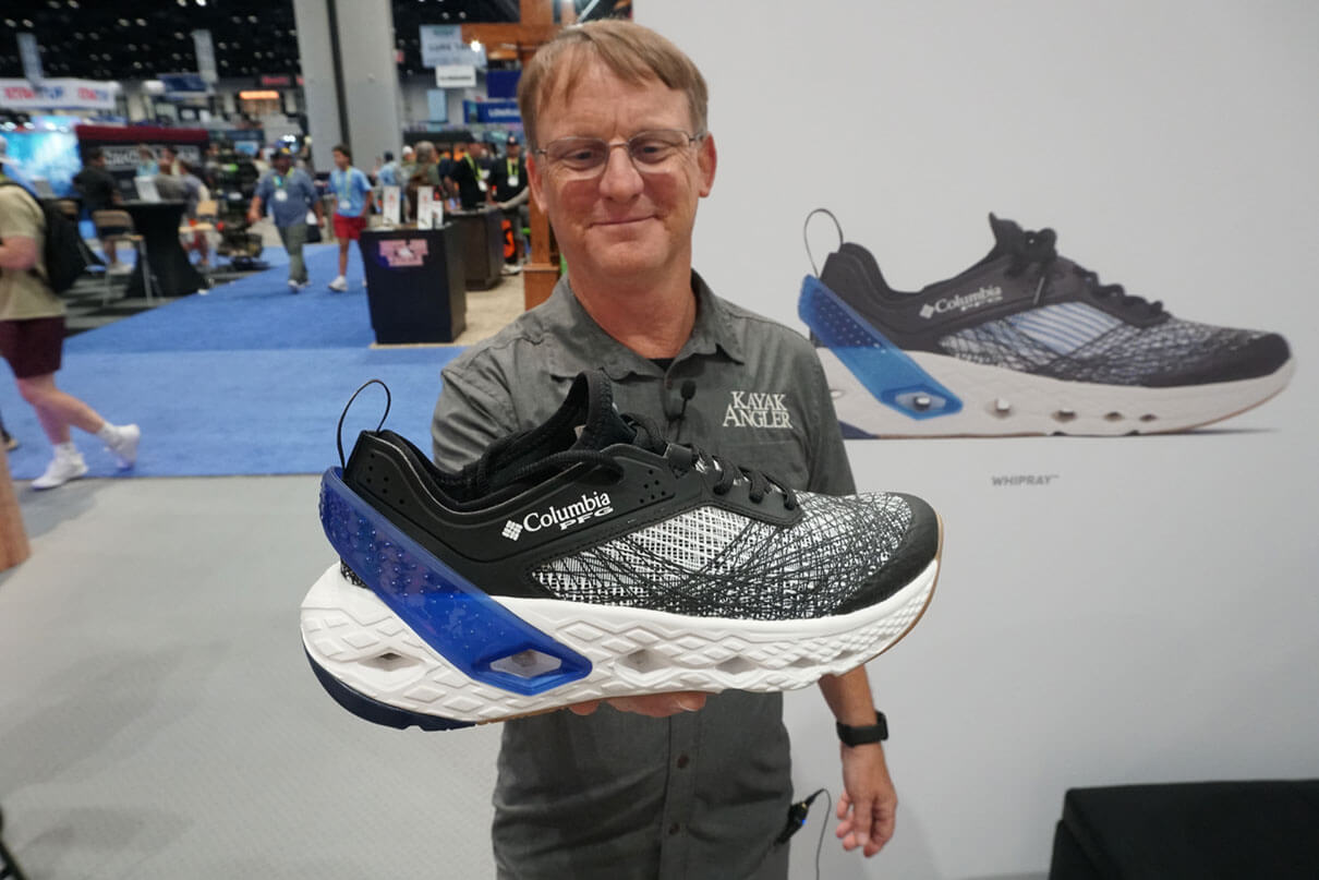 Kayak Angler editor Ric Burnley holds up the Columbia Whipray fishing shoe at ICAST 2025