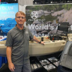 Ric Burnley poses in front of the FluxJet jet-powered kayak at ICAST 2025