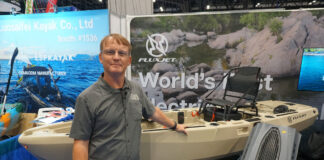 Ric Burnley poses in front of the FluxJet jet-powered kayak at ICAST 2025