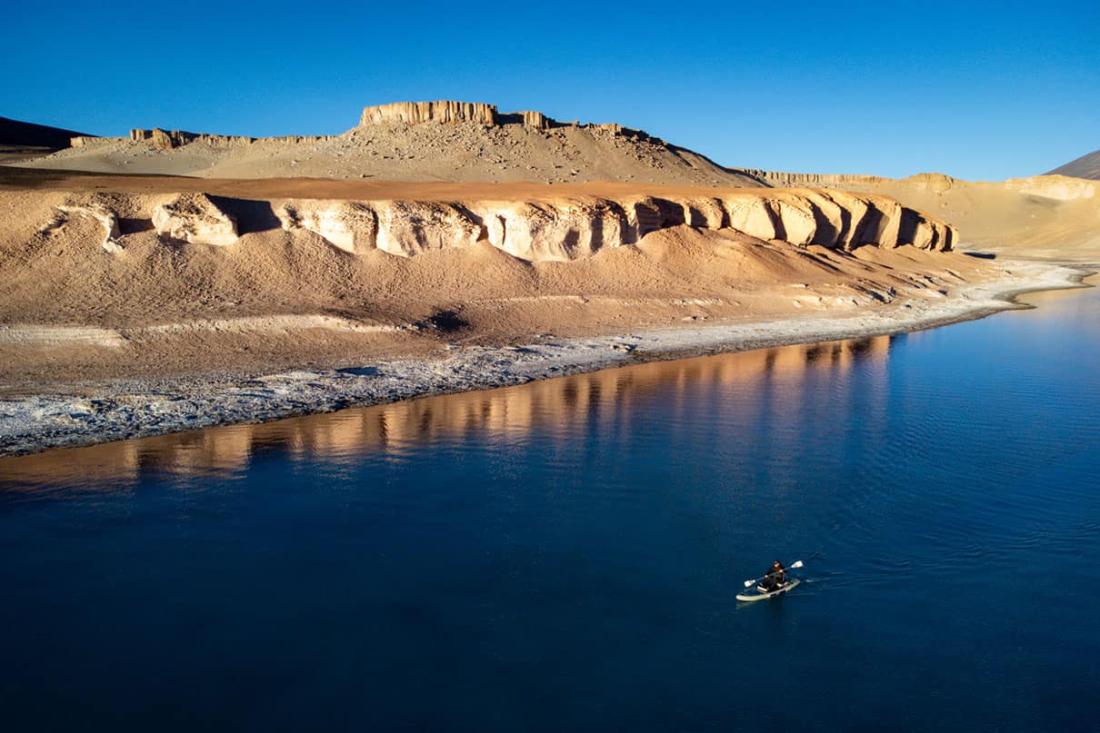 a man paddleboards on a high-altitude Chilean lake while setting the world record for highest elevation ever SUPed