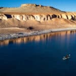 a man paddleboards on a high-altitude Chilean lake while setting the world record for highest elevation ever SUPed