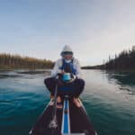 Craig Sawyer sits and eats on his paddleboard during the Yukon 1000 race