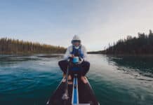 Craig Sawyer sits and eats on his paddleboard during the Yukon 1000 race