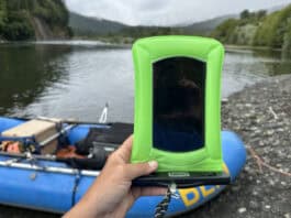 Holding phone up with raft and river gorge in the background.