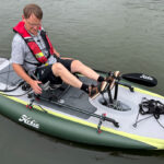 A man sits on an iTrek Hobie Angler with a pedal drive