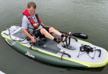A man sits on an iTrek Hobie Angler with a pedal drive