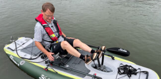 A man sits on an iTrek Hobie Angler with a pedal drive