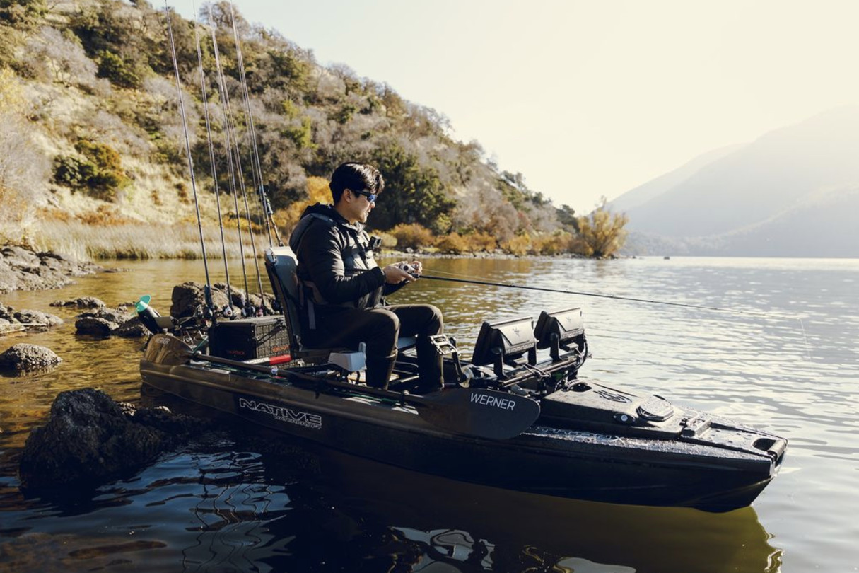 Man in big fishing kayak.
