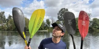 Best Kayak Paddles For 2026 Paddling Magazine editor Joe Potoczak holding up an assortment of the best kayak paddles on the market.