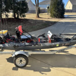 Fishing kayak with modifications in driveway.