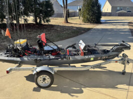 Fishing kayak with modifications in driveway.