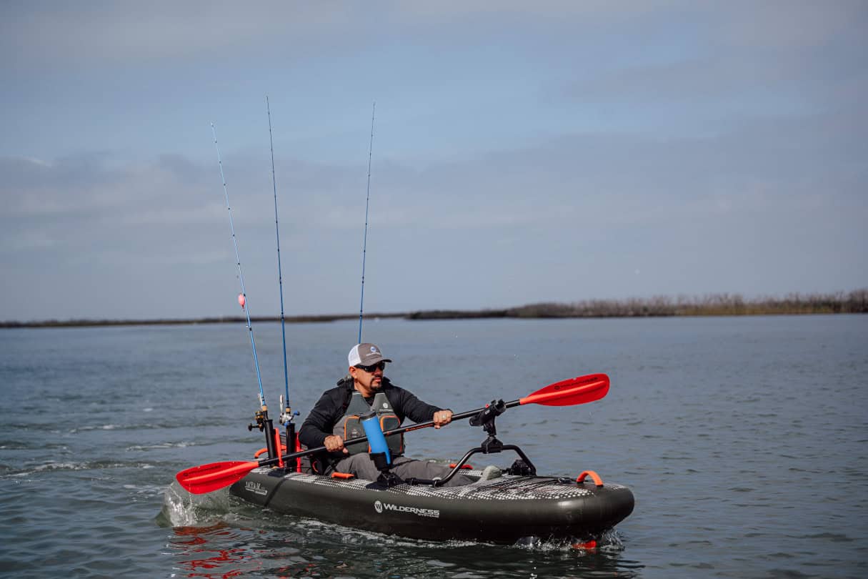Kayak Angler paddling across a bay.