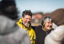 chef and expedition paddler Mike Keen stands and smiles with an Inuit woman while on his kayaking expedition around Greenland subsisting on an Inuit hunter's ancestral diet